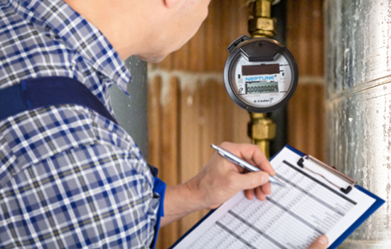 field technician checking water meter