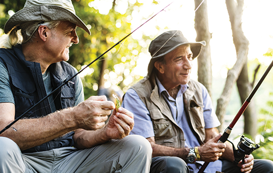 smiling men with fishing gear