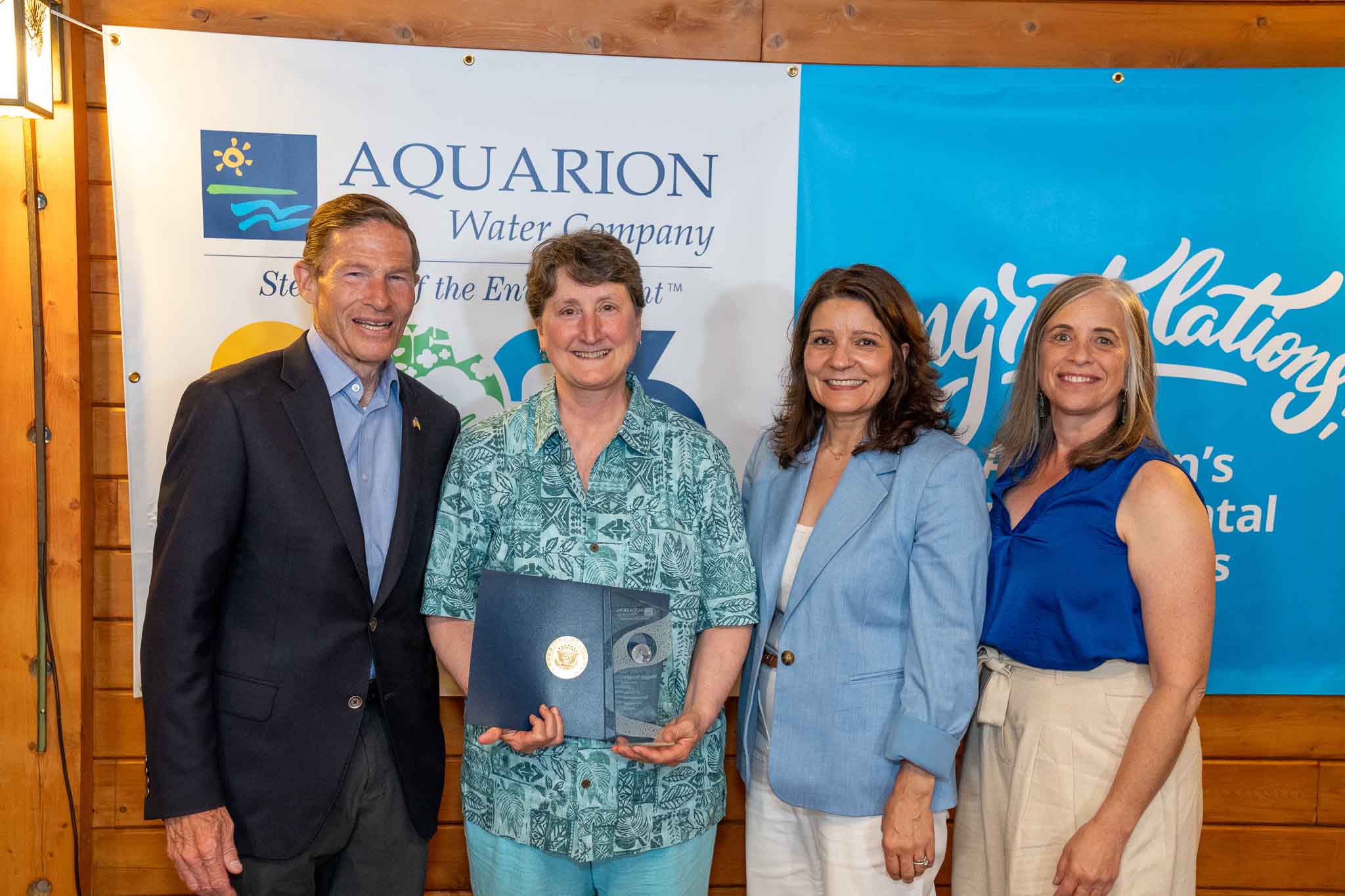 PHOTO (left to right): U.S. Senator Richard Blumenthal; Maggie Favretti, Co-Founder of the Alliance for the Mystic River Watershed; Lucy Teixeira, President of Aquarion Water Company; and Carolyn Giampe, Director of Watershed & Environmental Management at Aquarion Water Company.