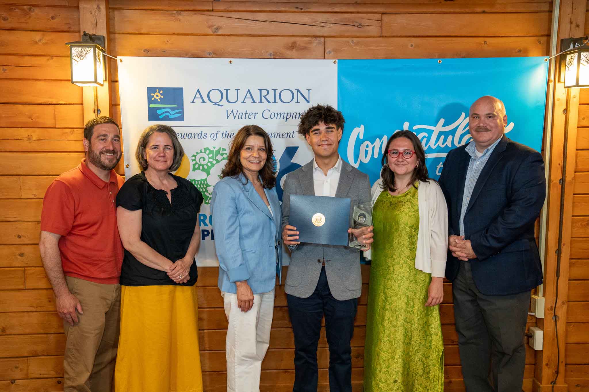PHOTO: Lucy Teixeira, President of Aquarion Water Company; Peter Fazekas, Director of Corporate Communications at Aquarion Water Company; and Tomás Gutiérrez and his family