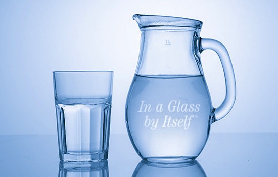 A pitcher and a glass of water